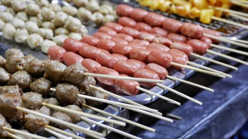 Close-up of meat on skewers at market stall