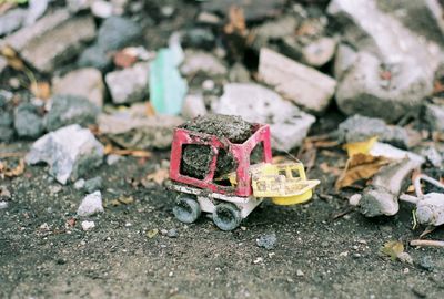 Close-up of abandoned toy on field