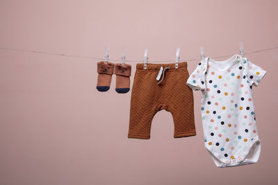 Close-up of clothes drying on clothesline against wall