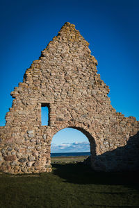 Old ruin building against clear blue sky