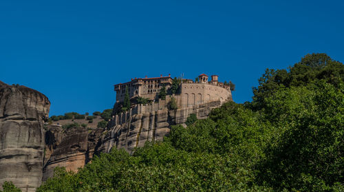 Low angle view of old ruins against clear blue sky