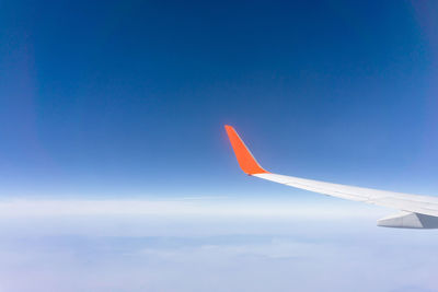 Sky scape view from clear glass window seat cabin crew to the aircraft wing of a plane