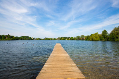 Pier over lake against sky