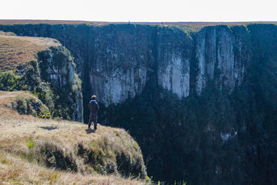 Rear view of man walking on rocks
