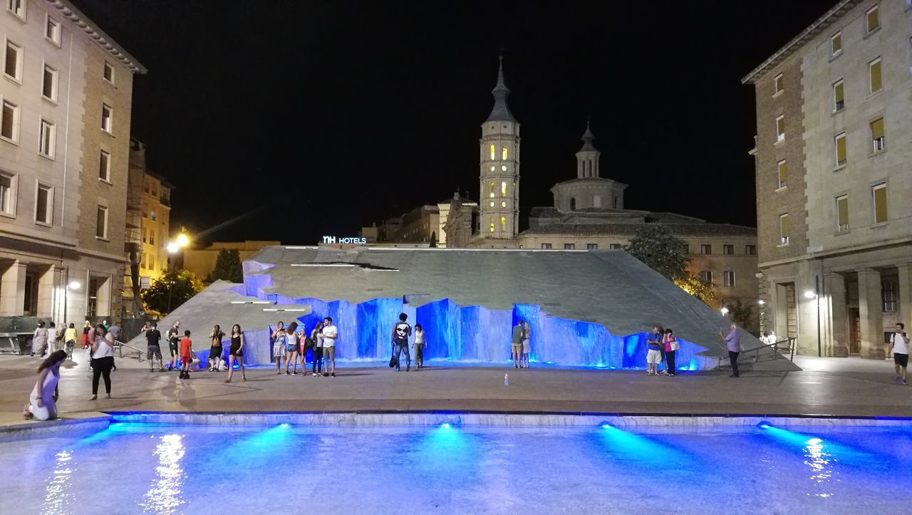 PEOPLE AT SWIMMING POOL IN CITY