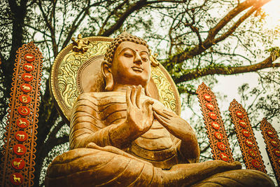 Low angle view of angel statue against temple