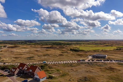 High angle view of houses on field against sky