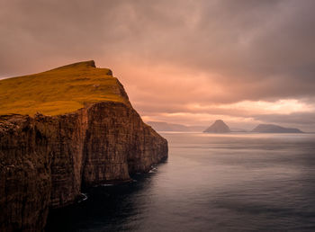 Scenic view of rock formation in sea against sky