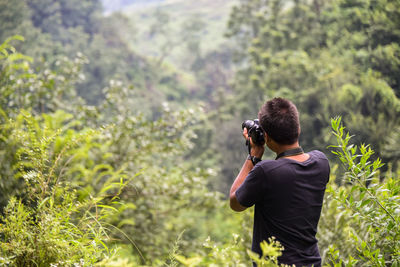 Rear view of man photographing