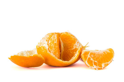 Close-up of orange fruit against white background