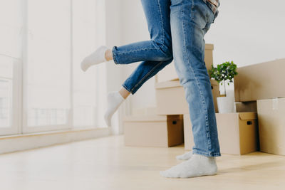 Carefree playful couple in new apartment