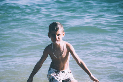 Portrait of happy boy in sea