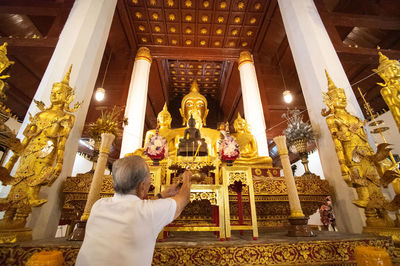 Rear view of statue against temple outside building