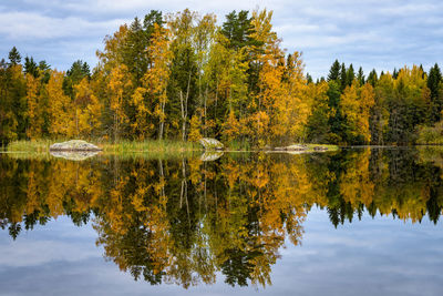 Reflection of trees in lake against sky during autumn