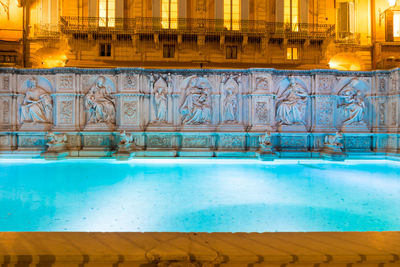 View of swimming pool at night