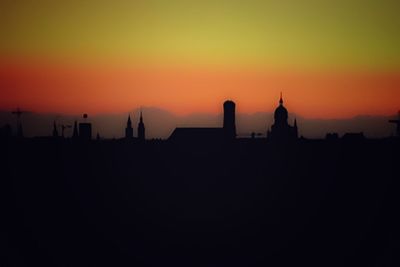 Silhouette city against sky during sunset