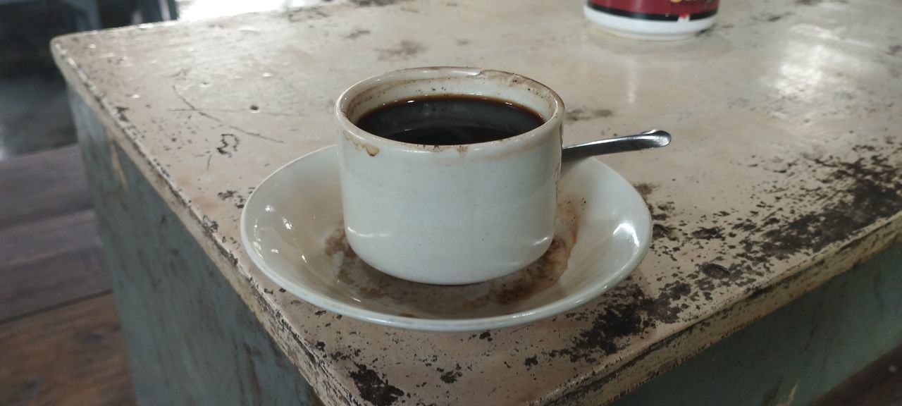 food and drink, drink, coffee, cup, refreshment, mug, coffee cup, table, indoors, freshness, high angle view, food, crockery, close-up, kitchen utensil, household equipment, no people, still life, focus on foreground, hot drink, saucer