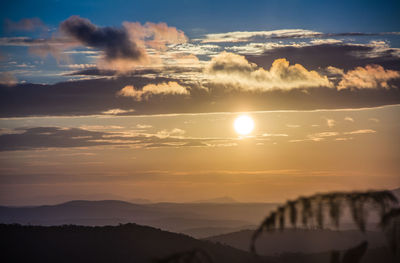 Scenic view of silhouette mountains against sky during sunset