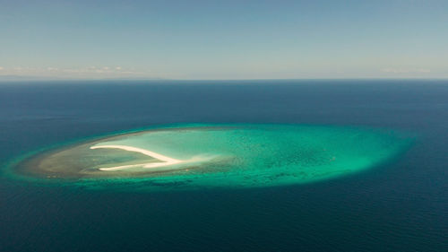 Aerial view of sea against clear blue sky