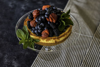 Cheesecake and berries with mint leaves