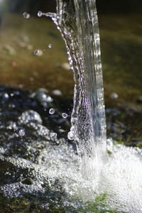 Close-up of water splashing against blurred background