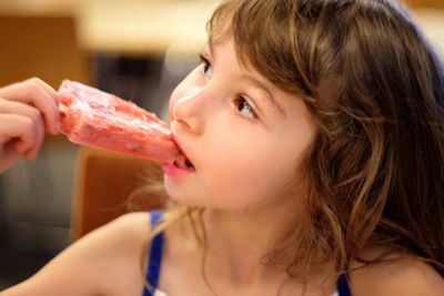 Close-up portrait of girl eating ice cream