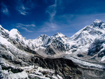 Scenic view of snowcapped mountains against blue sky