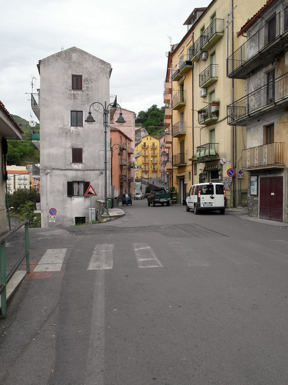 CARS ON ROAD AGAINST BUILDINGS