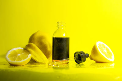 Close-up of fruits on table against yellow background