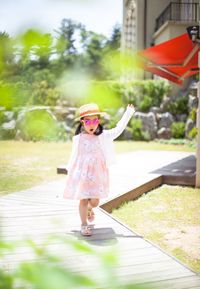 Full length of smiling girl on grass