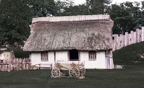 Old barn on field by building