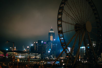 Ferris wheel in city at night