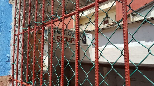 Close-up of chainlink fence against building