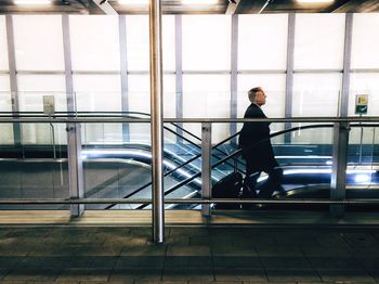 Full length of woman standing by railing