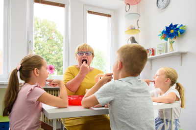 Children speech therapy concept. children practicing pronunciation with a female speech therapist. 