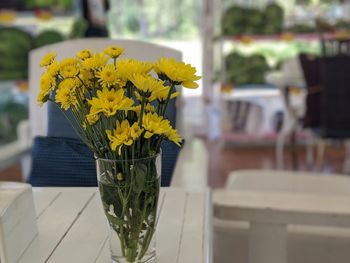 Close-up of yellow flower pot on table