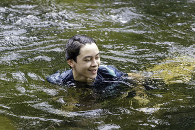 Portrait of young man swimming in water