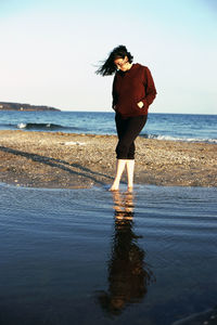 The woman standing on the beach