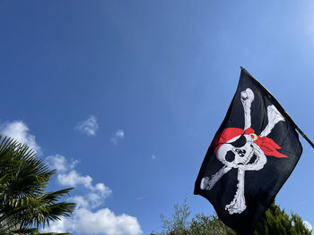 Low angle view of flag against sky