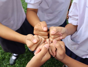 High angle view of friends giving fist bump