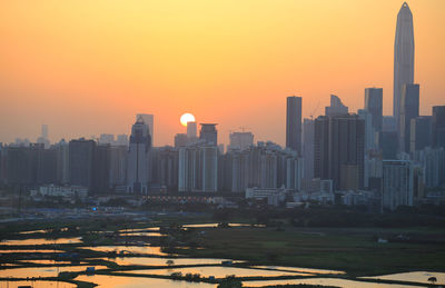 Urban skyline, sunset shenzhen against fishery ponds near hong kong boundary 