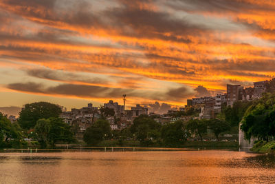 View of cityscape against cloudy sky during sunset