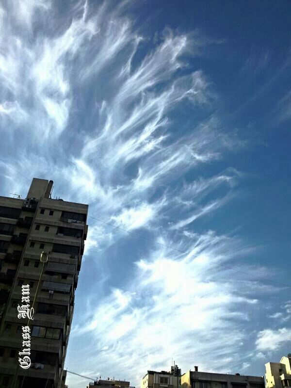 architecture, building exterior, built structure, sky, cloud - sky, low angle view, city, cloud, cloudy, building, residential building, outdoors, residential structure, no people, day, city life, blue, modern, cityscape, street light