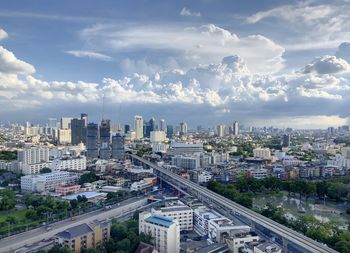 High angle view of modern buildings in city against sky