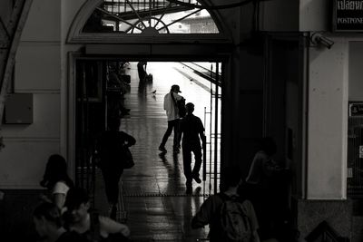 People walking in corridor of building