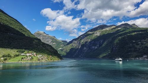 Scenic view of lake and mountains against sky near geirangerfjord - norway 