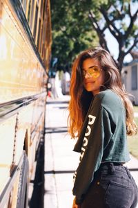 Young woman standing on sidewalk