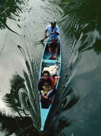 High angle view of family members in boat on lake