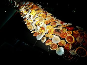 Low angle view of illuminated lanterns hanging at night