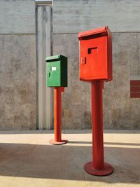 Close-up of city mailboxes against wall